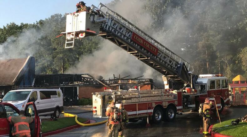 Cobb County firefighters battle a blaze at a day-care facility in Kennesaw.