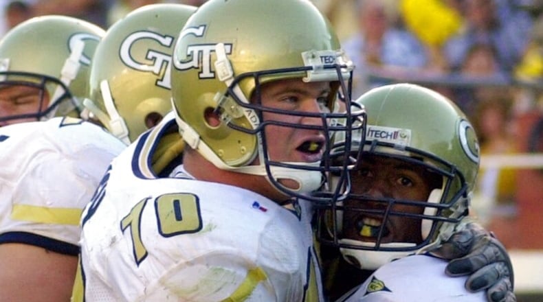 Georgia Tech receiver Will Glover, right, is hugged by offensive lineman Brent Key after scoring on a short pass in the second half of Tech's 40-13 victory over Navy in Atlanta, Saturday, Sept. 16, 2000. (AP Photo/John Bazemore)