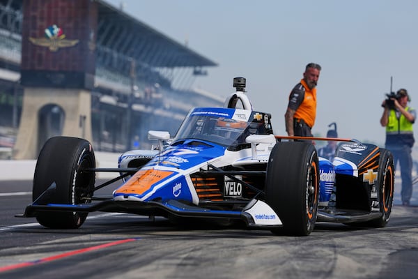 Tony Kanaan, of Brazil, pulls out of the pit area during practice for the Indianapolis 500 auto race at Indianapolis Motor Speedway in Indianapolis, Thursday, May 15, 2025. (AP Photo/Michael Conroy)