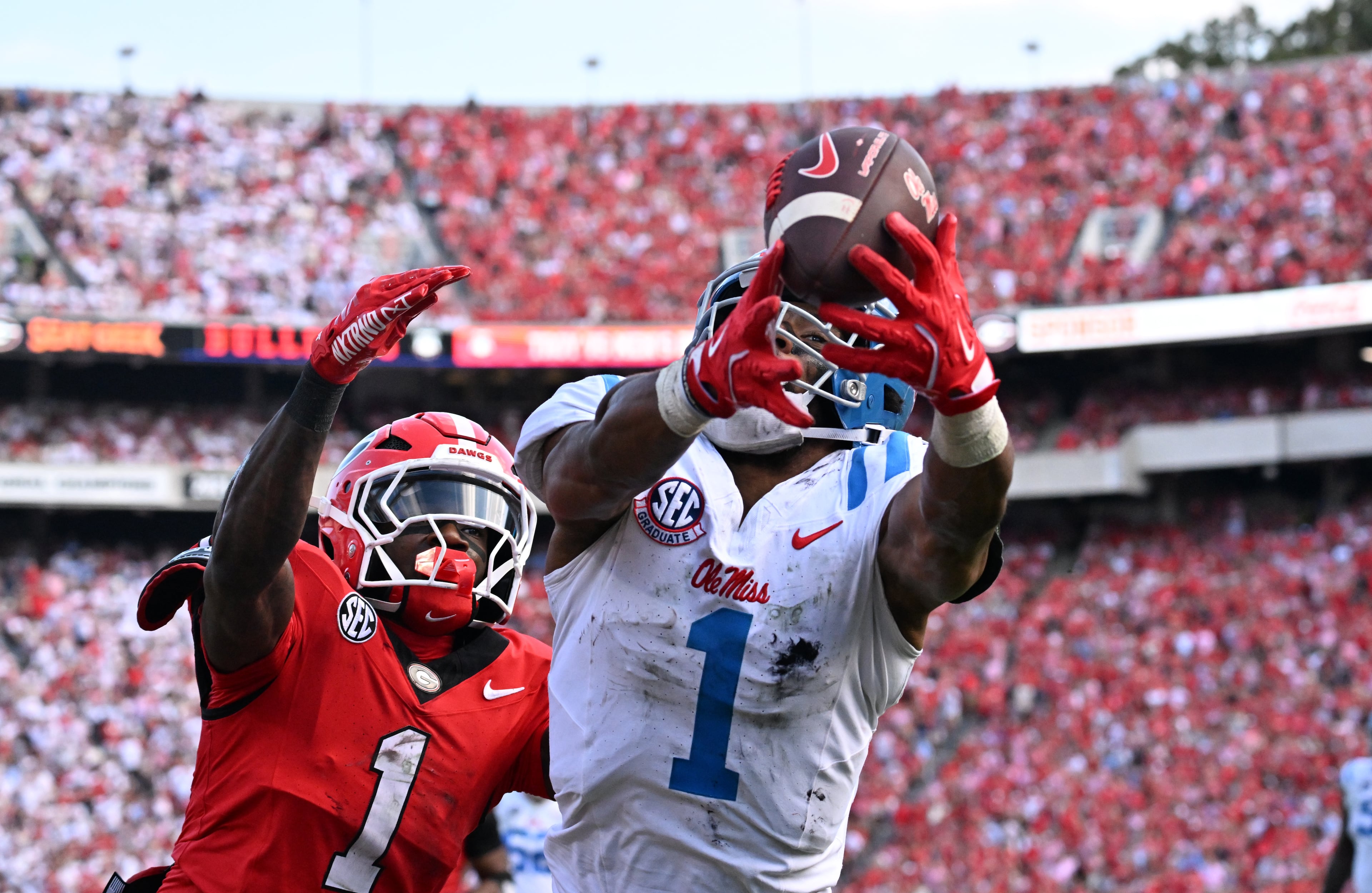 Mississippi wide receiver De'Zhaun Stribling (1) is not able to catch under pressure from Georgia defensive back Ellis Robinson IV (1) during the first half in an NCAA football game at Sanford Stadium, Saturday, October 18, 2025, in Athens. (Hyosub Shin / AJC)