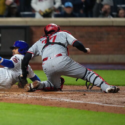 New York Mets' Francisco Lindor, left, slides past Minnesota Twins catcher Victor Caratini to score on a double by Francisco Alvarez during the fourth inning of a baseball game Wednesday, April 22, 2026, in New York. (AP Photo/Frank Franklin II)