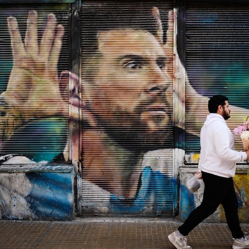 A man walks past by a mural of Argentina soccer player Lionel Messi in Buenos Aires, Argentina, Monday, Aug. 31, 2026. (AP Photo/Natacha Pisarenko)