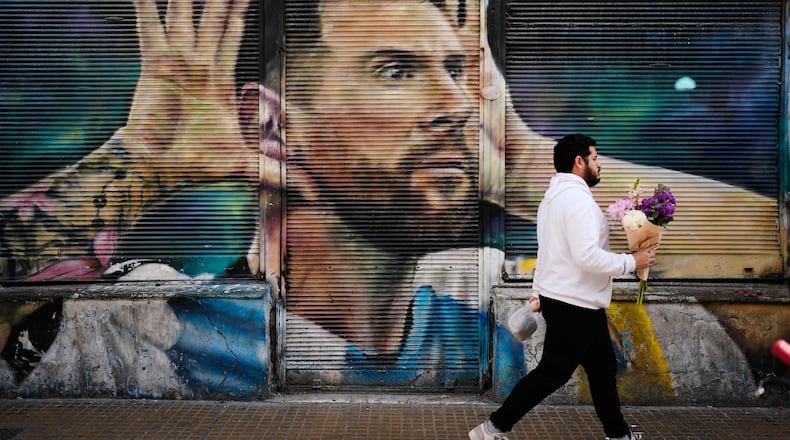 A man walks past by a mural of Argentina soccer player Lionel Messi in Buenos Aires, Argentina, Monday, Aug. 31, 2026. (AP Photo/Natacha Pisarenko)