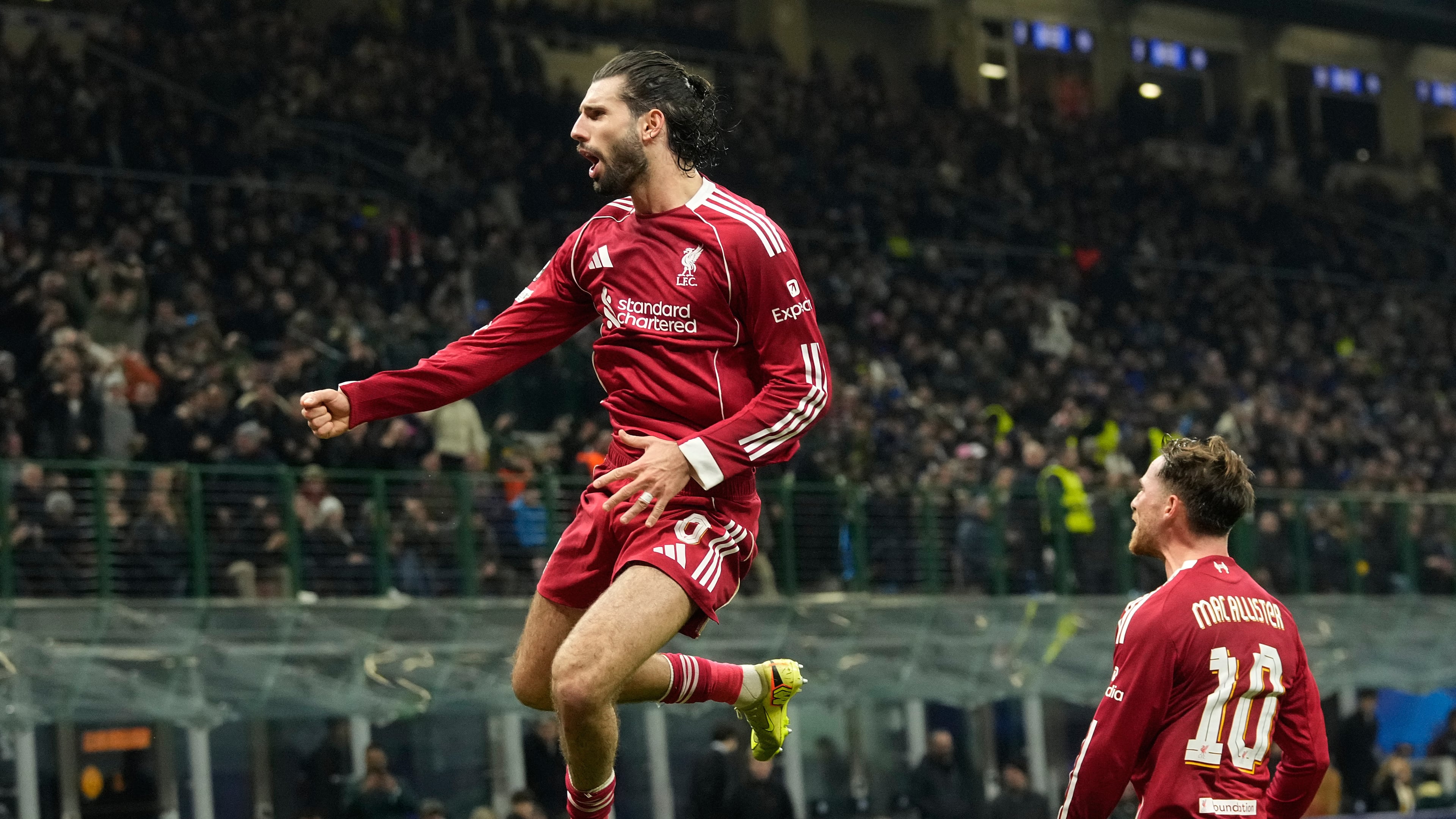 Liverpool's Dominik Szoboszlai celebrates after scoring his side's first goal from a penalty shot during a Champions League, league phase, soccer match between Inter Milan and Liverpool in Milan, Italy, Tuesday, Dec.9, 2025. (AP Photo/Luca Bruno)