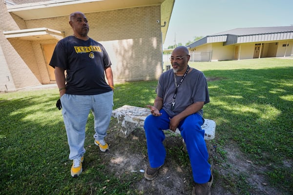 Alumnus Brian Davis, right, and assistant football coach Derrick Davis talk outside Ferriday High School in Ferriday, La., Thursday, May 22, 2025. (AP Photo/Gerald Herbert)