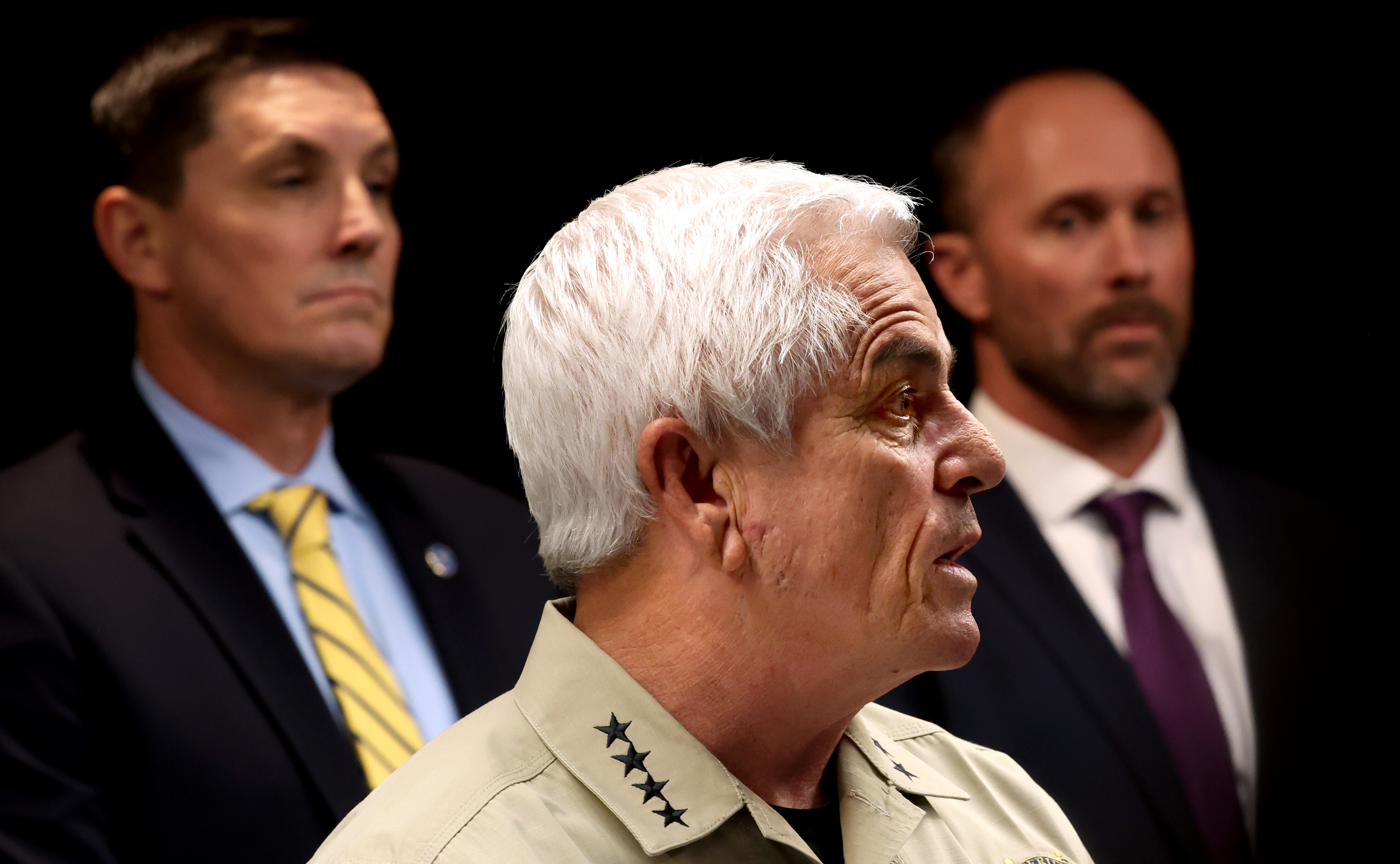 Pima County Sheriff Chris Nanos center, speaks at press conference with FBI special agent in charge, Phoenix, Heith Janke, left, and assistant special agent in charge, Tucson, Jon Edwards, during a briefing at the Pima County Sheriff's Department on a Border Patrol involved shooting, Tuesday, Jan. 27, 2026, Tucson, Ariz. (Kelly Presnell/Arizona Daily Star via AP)