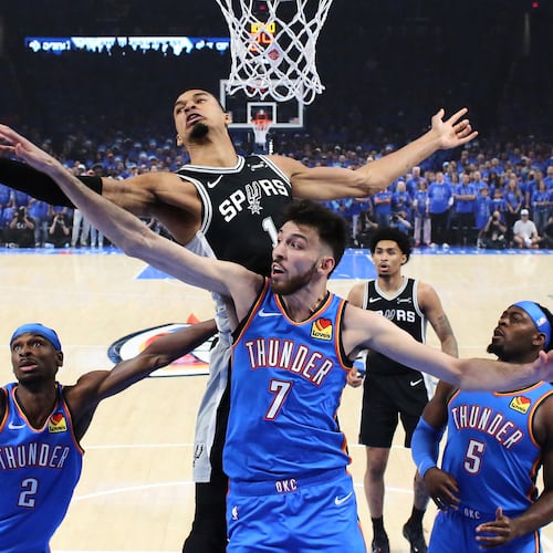 San Antonio Spurs forward Victor Wembanyama (1) and Oklahoma City Thunder center Chet Holmgren (7) reach for a rebound during the first half of Game 1 in a third-round NBA basketball playoffs series Monday, May 18, 2026, in Oklahoma City. (AP Photo/Nate Billings)