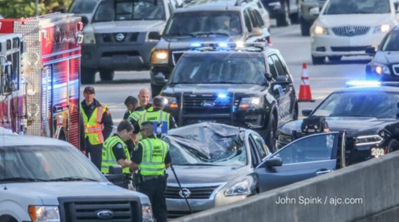 Police respond to a deadly accident on a metro Atlanta freeway that caused a massive back-up in both directions Thursday morning. A tire flew off a pick-up truck and struck a driver in the opposite lanes, killing her on the spot.