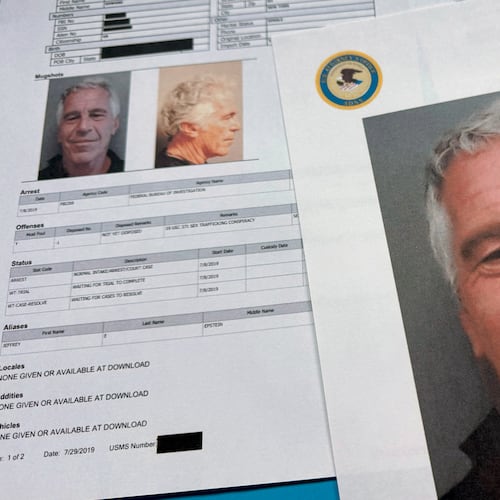 Documents that were included in the U.S. Department of Justice release of the Jeffrey Epstein files are photographed Friday, Jan. 2, 2026. (AP Photo/Jon Elswick)