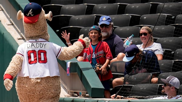Braves mascot Blooper greets a young fan during Sunday's Father's Day festivities at Truist Park.