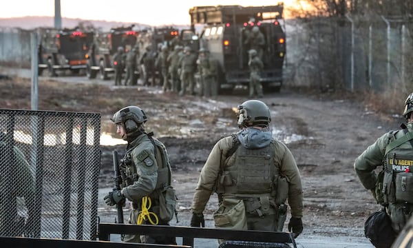 Law enforcement officers work to clear the woods at the site of Atlanta’s public safety training center on Monday, Feb. 6, 2023, in anticipation of construction of the controversial facility. (John Spink/AJC)