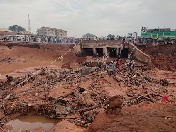 People search in flooded area following a downpour in Mokwa, Nigeria, Friday, May 30, 2025. (AP Photo/Chenemi Bamaiyi)