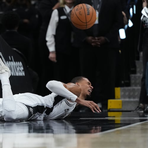 San Antonio Spurs forward Victor Wembanyama (1) takes a hard fall on the court during the first half in Game 2 of a first-round NBA playoffs basketball series against the Portland Trail Blazers in San Antonio, Tuesday, April 21, 2026. (AP Photo/Eric Gay)