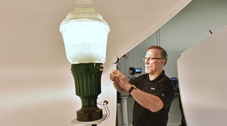 Don Mason, senior lab technician, measures the light of an LED post top lamp at Acuity Brands’ lab in Decatur in this 2016 photo. HYOSUB SHIN / HSHIN@AJC.COM