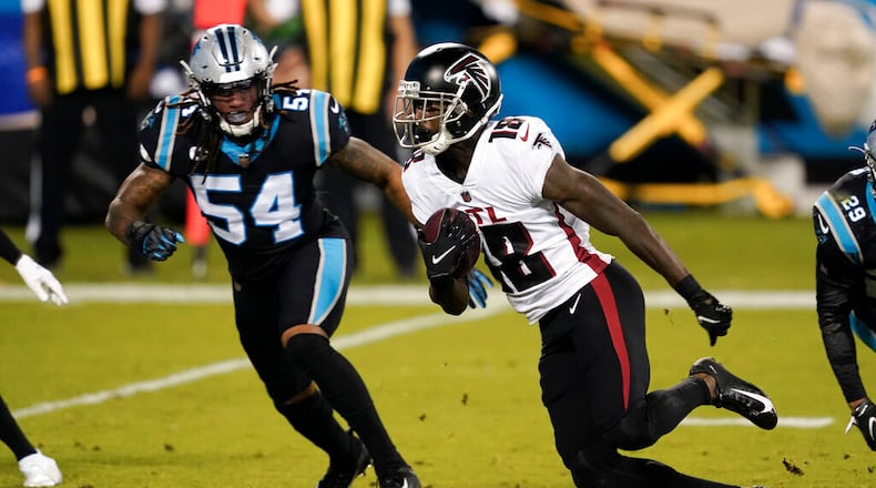 Atlanta Falcons wide receiver Calvin Ridley runs past Carolina Panthers outside linebacker Shaq Thompson during the first half of an NFL football game Thursday, Oct. 29, 2020, in Charlotte, N.C. (AP Photo/Gerry Broome)