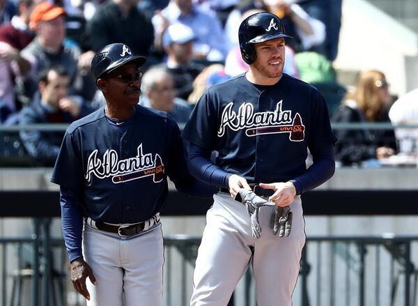 Freddie Freeman gets a pat on the back from third-base coach Ron Washington after Freeman's opening-day triple Monday against the Mets. (Getty Images)
