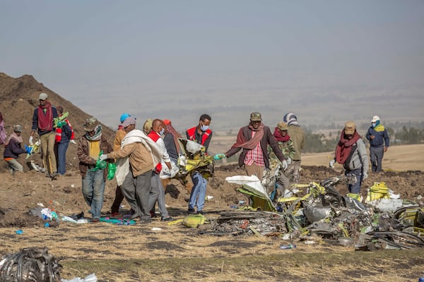 FILE - Rescuers work at the scene of an Ethiopian Airlines flight of a Boeing 737 Max 8 plane crash near Bishoftu, or Debre Zeit, south of Addis Ababa, Ethiopia, March 11, 2019. (AP Photo/Mulugeta Ayene, File)