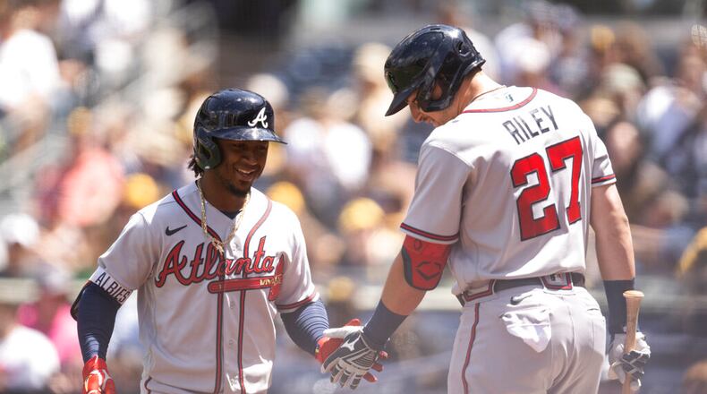 Atlanta Braves' Ozzie Albies, left, celebrates his solo home run with Austin Riley during the first inning of a baseball game against the San Diego Padres in San Diego, Saturday, April 16, 2022. (AP Photo/Kyusung Gong)
