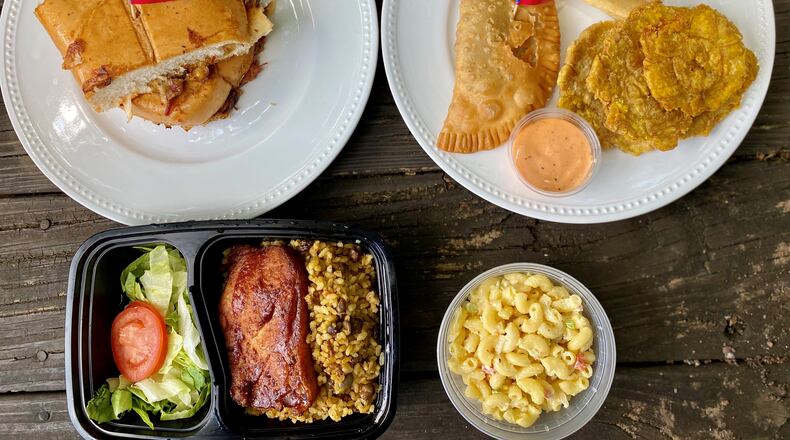 A takeout order from My Abuelas Food includes La Tripleta de Mr. Pig sandwich; an appetizer sampler with a beef empanadilla, tostones and fried yuca; and Valeria’s Birthday Plate (fried pork chop, rice and peas and pasta salad).
Wendell Brock for The Atlanta Journal-Constitution