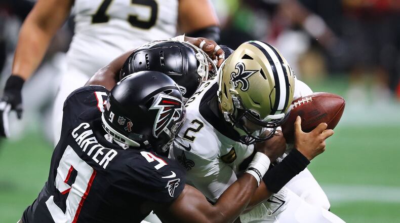 Atlanta Falcons outside linebacker Lorenzo Carter and defensive lineman Grady Jarrett sack New Orleans Saints quarterback Jameis Winston for a loss on third down during the second quarter Sunday, Sept. 11, 2022, in Atlanta. (Curtis Compton/The Atlanta Journal-Constitution/TNS)