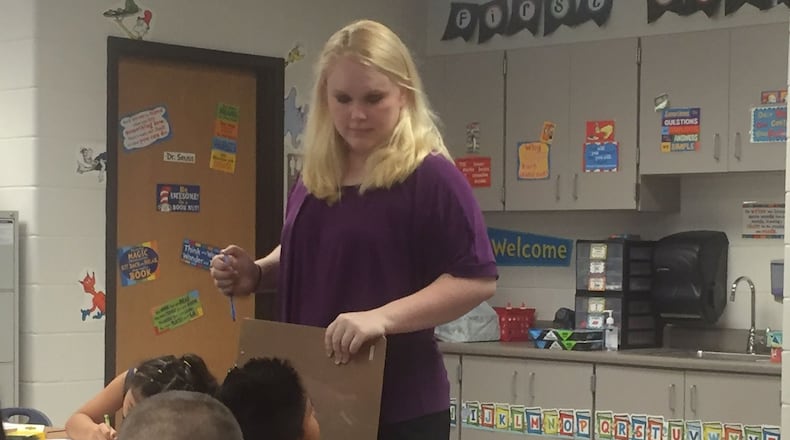 Baldwin Elementary School first grade teacher Audrey Smith instructs a student on the first day of school in Gwinnett County on Monday, Aug. 8, 2016. Smith has never taught before. Baldwin is one of two new schools that opened in Gwinnett. ERIC STIRGUS