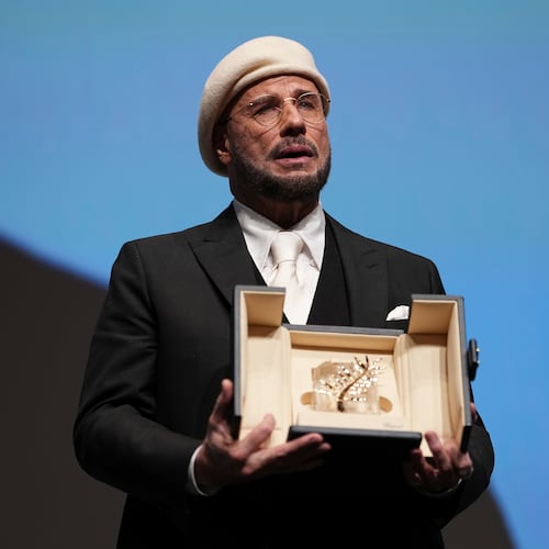 John Travolta holds his honorary Palme d'Or during the 79th international film festival, Cannes, southern France, Friday, May 15, 2026. (Photo by Scott A Garfitt/Invision/AP)
