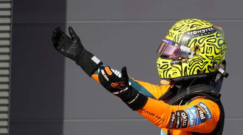 McLaren driver Lando Norris of Britain celebrates after winning the Formula One Hungarian Grand Prix auto race, at the Hungaroring racetrack in Mogyorod, near Budapest, Hungary, Sunday, July 26, 2026. (AP Photo/Darko Bandic)