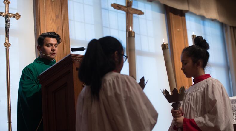The Rev. Rey Pineda, a DACA recipient, during Mass at Cathedral of Christ the King, on Saturday in Atlanta. BRANDEN CAMP/SPECIAL