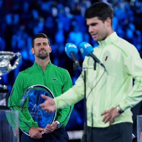 Novak Djokovic of Serbia watches Carlos Alcaraz of Spain give his victory speech after winning the men's singles final at the Australian Open tennis championship in Melbourne, Australia, Sunday, Feb. 1, 2026. (AP Photo/Aaron Favila)