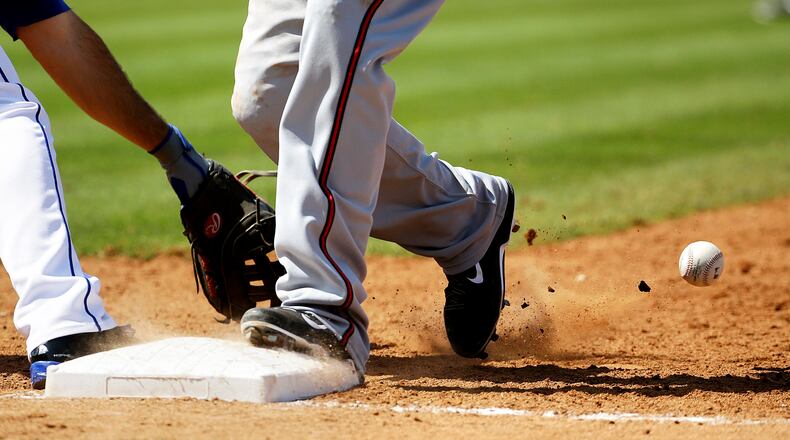 A throw by New York Mets pitcher Kyle Farnsworth gets by the glove of first baseman Josh Satin, left, on a pickoff attempt of Atlanta Braves' Tyler Greene, right, allowing Greene to advance to third base in the seventh inning of an exhibition spring training baseball game, Thursday, March 20, 2014, in Port St. Lucie, Fla. (AP Photo/David Goldman)