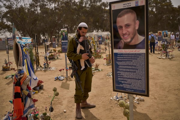 FILE - An Israeli soldier walks at the site of Oct. 7, 2023, attack by Hamas militants at the Nova music festival near Kibbutz Reim, southern Israel, April 30, 2025. (AP Photo/Ohad Zwigenberg, File)