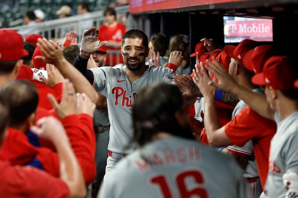 Philadelphia Phillies' Nick Castellanos celebrates with teammates after hitting a home run during the second inning of a baseball game against the Atlanta Braves, Friday, June 27, 2025, in Atlanta. (AP Photo/Butch Dill)
