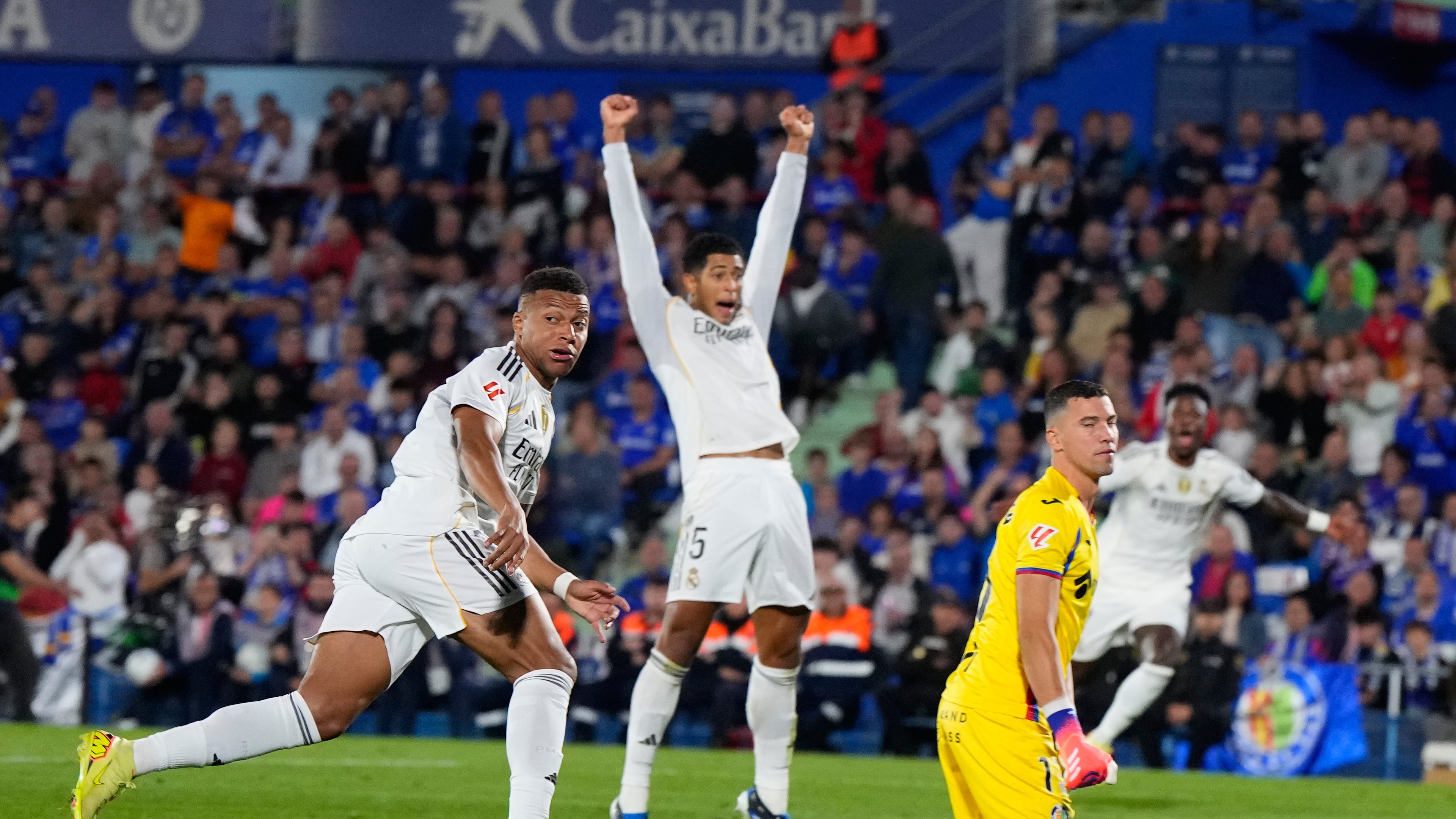 Real Madrid's Kylian Mbappe, left, looks at the ball after scoring during a La Liga soccer match between Getafe and Real Madrid in Getafe, Spain, Sunday, Oct. 19, 2025. (AP Photo/Manu Fernandez)