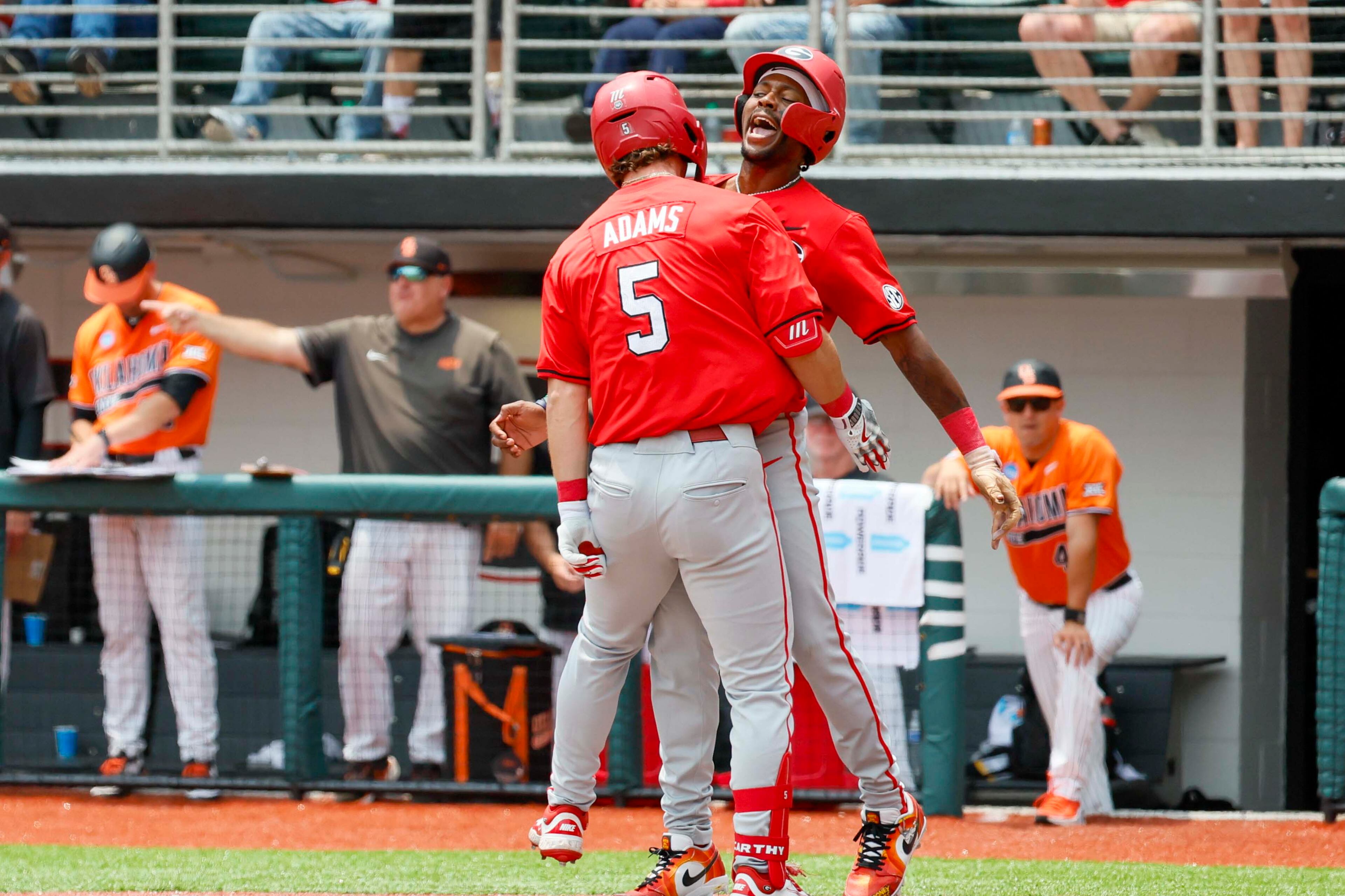 Georgia infielder Christian Adams (5) celebrates at home plate with Georgia infielder Tre Phelps (1) after hitting a two-run home run during the second inning against Oklahoma State in their NCAA Regional game at Foley Field,  Sunday, June 1, 2025, in Athens, Ga.
(Miguel Martinez/ AJC)