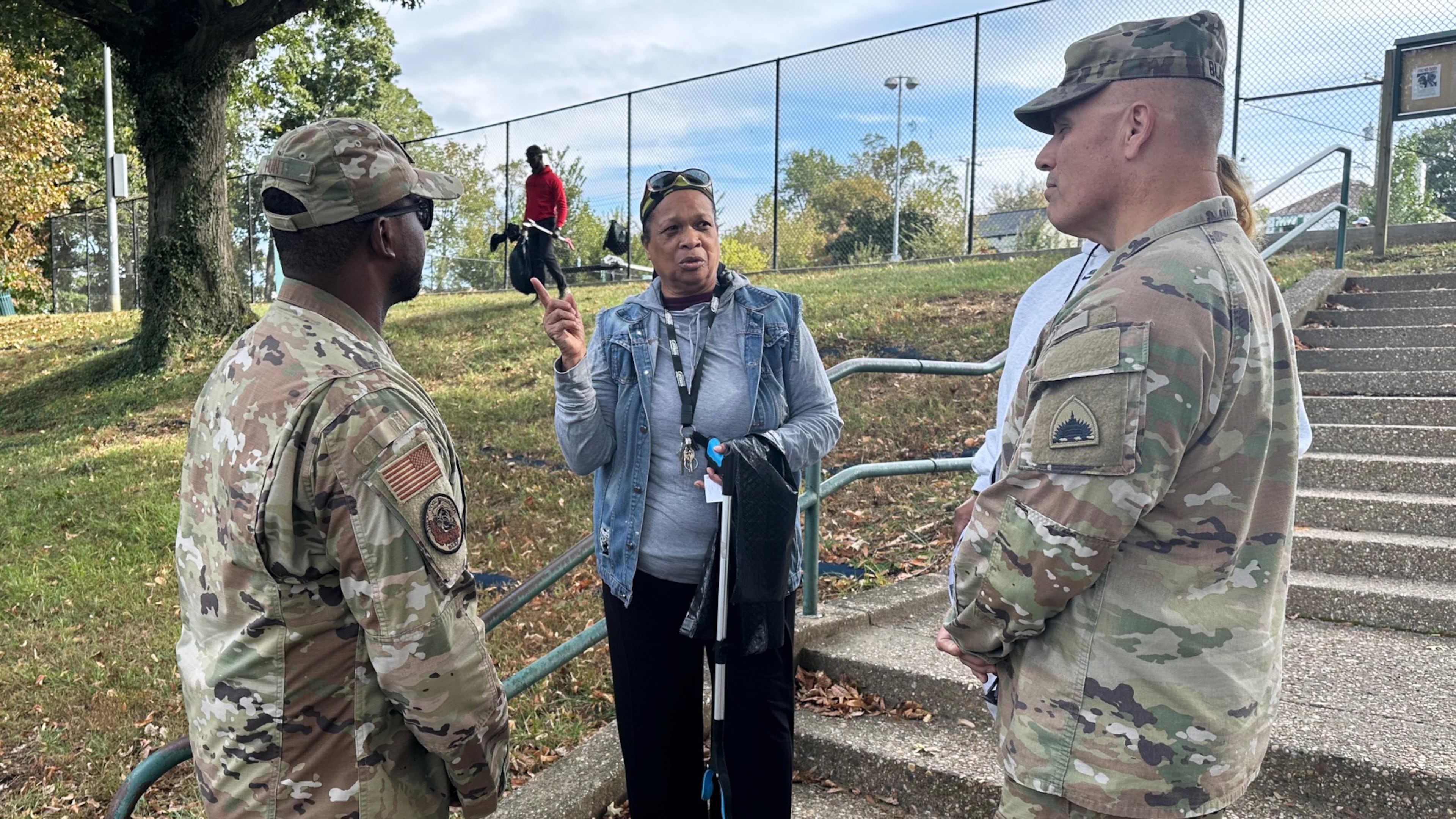 Neighborhood resident and volunteer, Valencia Mohammed, center, talks to D.C. National Guard interim commander Army Brig. Gen. Leland Blanchard II, right, and Lt. Col. Marcus Hunt, left, about cleanup efforts at Fort Stevens Recreation Center, Saturday, Oct. 11, 2025, in Washington. Mohammed requested the cleanup. Marcus Hickman, Anacostia ANC Commisioner, is seen rear. (AP Photo/Gary Fields)