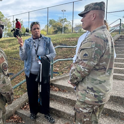 Neighborhood resident and volunteer, Valencia Mohammed, center, talks to D.C. National Guard interim commander Army Brig. Gen. Leland Blanchard II, right, and Lt. Col. Marcus Hunt, left, about cleanup efforts at Fort Stevens Recreation Center, Saturday, Oct. 11, 2025, in Washington. Mohammed requested the cleanup. Marcus Hickman, Anacostia ANC Commisioner, is seen rear. (AP Photo/Gary Fields)