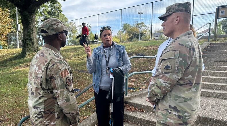 Neighborhood resident and volunteer, Valencia Mohammed, center, talks to D.C. National Guard interim commander Army Brig. Gen. Leland Blanchard II, right, and Lt. Col. Marcus Hunt, left, about cleanup efforts at Fort Stevens Recreation Center, Saturday, Oct. 11, 2025, in Washington. Mohammed requested the cleanup. Marcus Hickman, Anacostia ANC Commisioner, is seen rear. (AP Photo/Gary Fields)