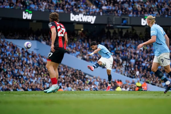 Manchester City's Omar Marmoush scores his side's opening goal during the English Premier League soccer match between Manchester City and Bournemouth at the Etihad stadium in Manchester, England, Tuesday, May 20, 2025. (AP Photo/Dave Thompson)