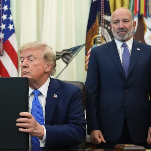 President Donald Trump listens before signing executive orders in the Oval Office of the White House, Thursday, Aug. 6, 2026, in Washington, as Commerce Secretary Howard Lutnick watches. (AP Photo/Alex Brandon)