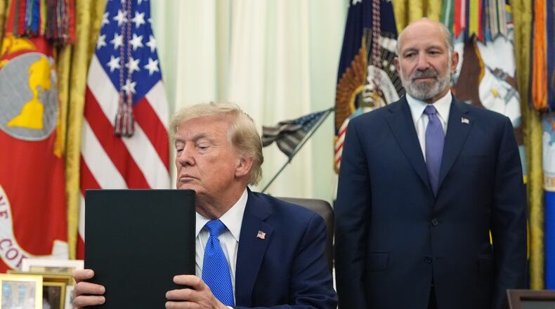President Donald Trump listens before signing executive orders in the Oval Office of the White House, Thursday, Aug. 6, 2026, in Washington, as Commerce Secretary Howard Lutnick watches. (AP Photo/Alex Brandon)