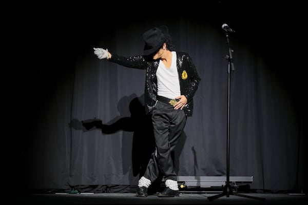 A Michael Jackson impersonator performs during the Athens Football Kickoff celebration at the Akins Ford Arena on Thursday. (Jason Getz/AJC)