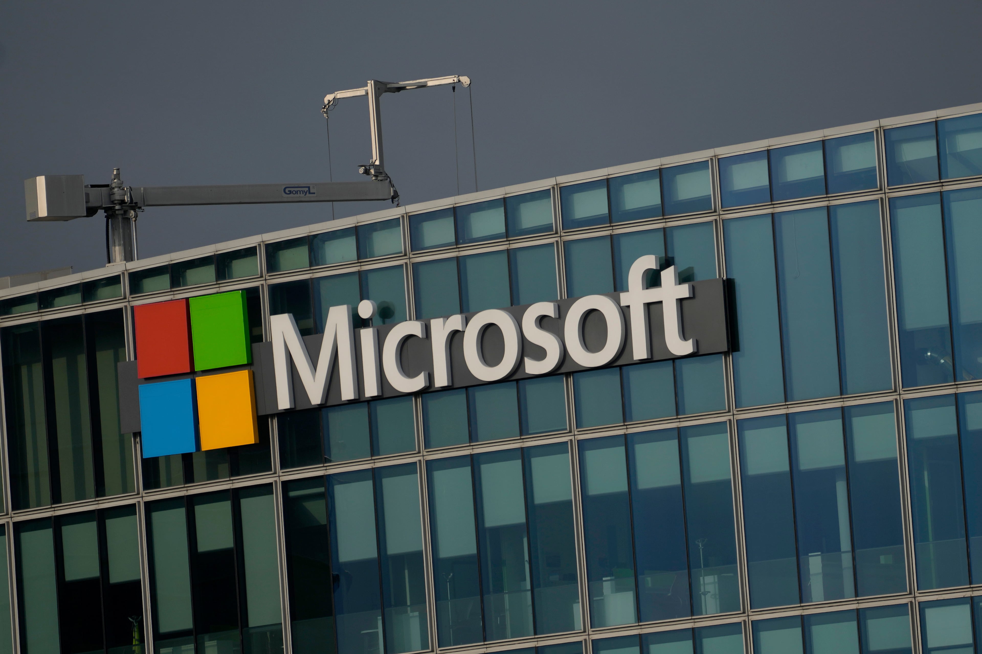 The logo of Microsoft is seen outside its French headquarters in Issy-les-Moulineaux. Atlanta Mayor Andre Dickens says the tech giant will partner with the city to help it build more affordable housing in the Grove Park neighborhood. (Thibault Camus/AP 2024)