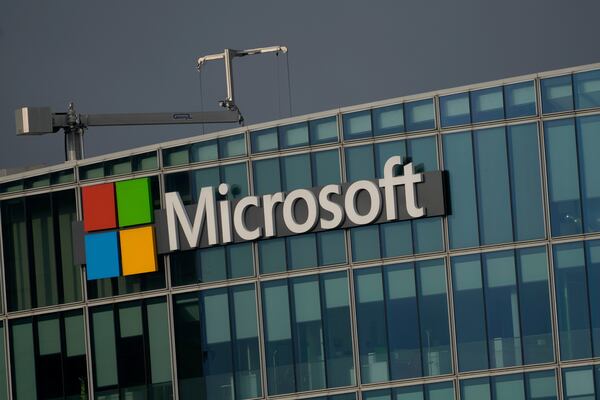 The logo of Microsoft is seen outside its French headquarters in Issy-les-Moulineaux. Atlanta Mayor Andre Dickens says the tech giant will partner with the city to help it build more affordable housing in the Grove Park neighborhood. (Thibault Camus/AP 2024)