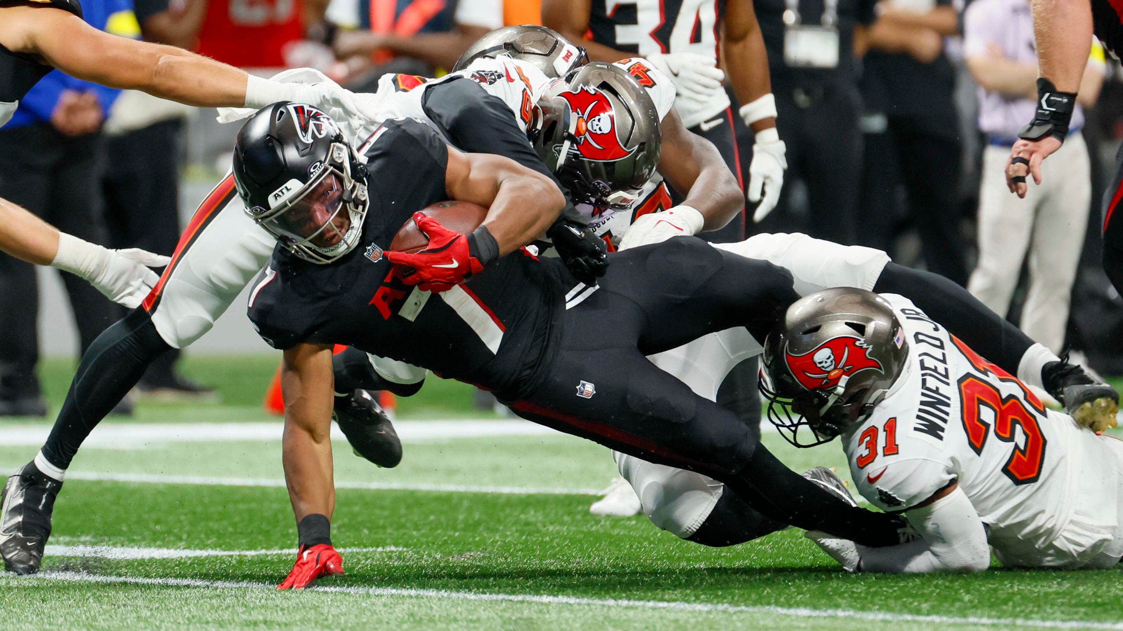 Atlanta Falcons running back Bijan Robinson is tackled during the second half of September's game against the Tampa Bay Buccaneers. (Miguel Martinez/AJC)