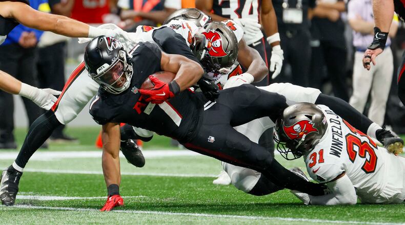 Atlanta Falcons running back Bijan Robinson is tackled during the second half of September's game against the Tampa Bay Buccaneers. (Miguel Martinez/AJC)