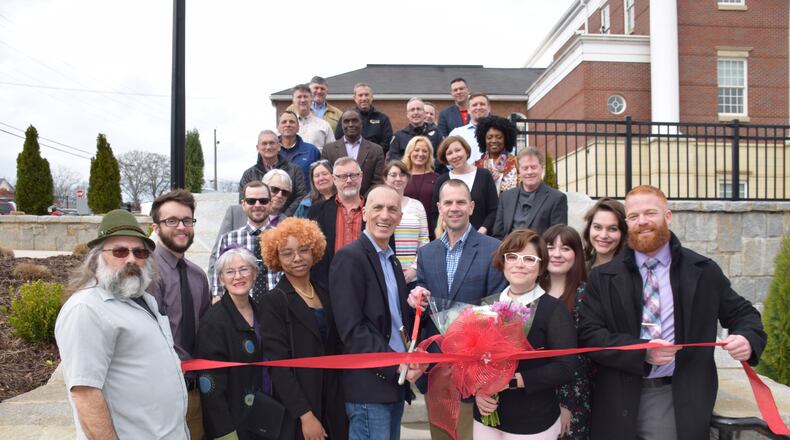 The city of Kennesaw held a ribbon cutting to unveil eight manhole covers created by KSU students.
