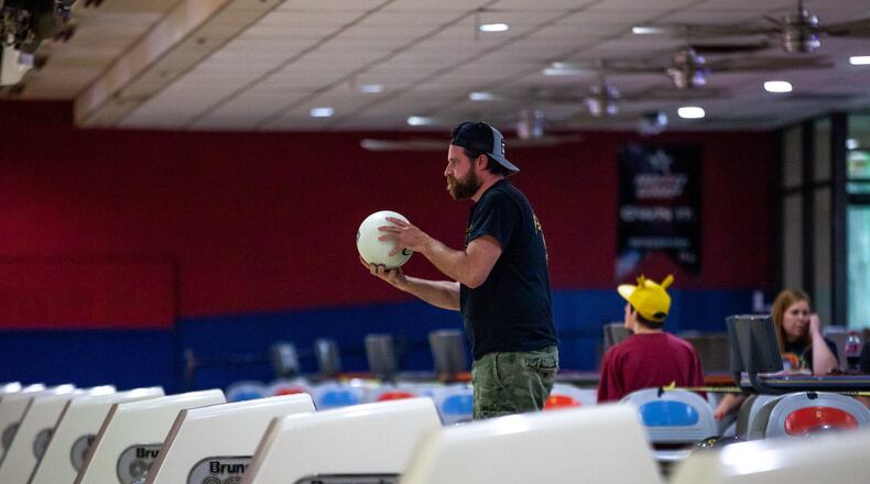 Ryan Lowery prepares to roll a bowling ball, Friday, April 24, 2020 in Douglasville, Ga. Gov. Kemp announced that gyms, barber shops, hair salons, tattoo parlors and bowling alleys can all reopen to help relieve strain on Georgia’s economy. BRANDEN CAMP/SPECIAL