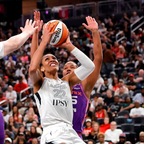 Las Vegas Aces center A'ja Wilson (22) looks to shoot between Phoenix Mercury center Kyara Linskens (31) and forward Alyssa Thomas, right, during the first half of an WNBA basketball game Saturday, May 9, 2026, in Las Vegas. (Steve Marcus/Las Vegas Sun via AP)