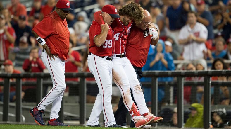 Washington Nationals right fielder Bryce Harper gets helped off the field after slipping on first base in an Saturday, Aug. 12, 2017 game against the San Francisco Giants.
