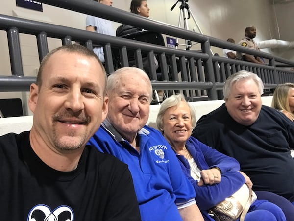 Then-Newton coach Rick Rasmussen (left), Ronald and Jan Bradley (center), son Brad Bradley (right) at a Newton basketball game in 2018. (Photo courtesy Rick Rasmussen)